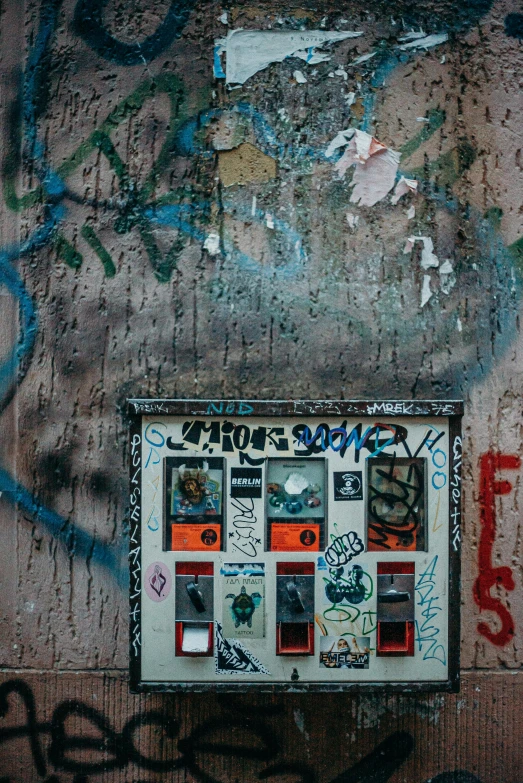 a wall covered in lots of graffiti next to a fire hydrant, inspired by Elsa Bleda, pexels contest winner, vending machine, weathered polaroid, 5 fingers, radio box
