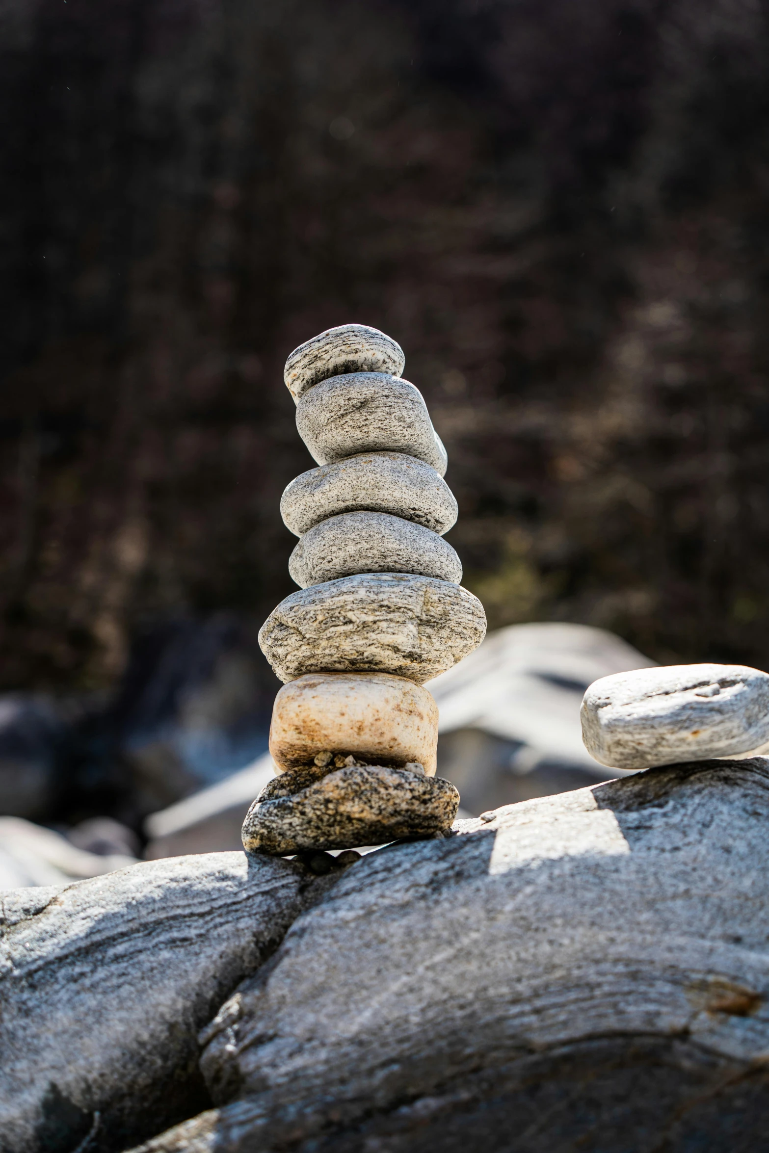 a stack of rocks sitting on top of a rock, a marble sculpture, inspired by Andy Goldsworthy, unsplash, paul barson, low-angle, norway, snacks