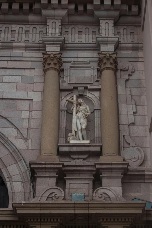 a clock that is on the side of a building, a statue, by Michelangelo, romanesque, low quality photograph, archs, single figure, inside the building