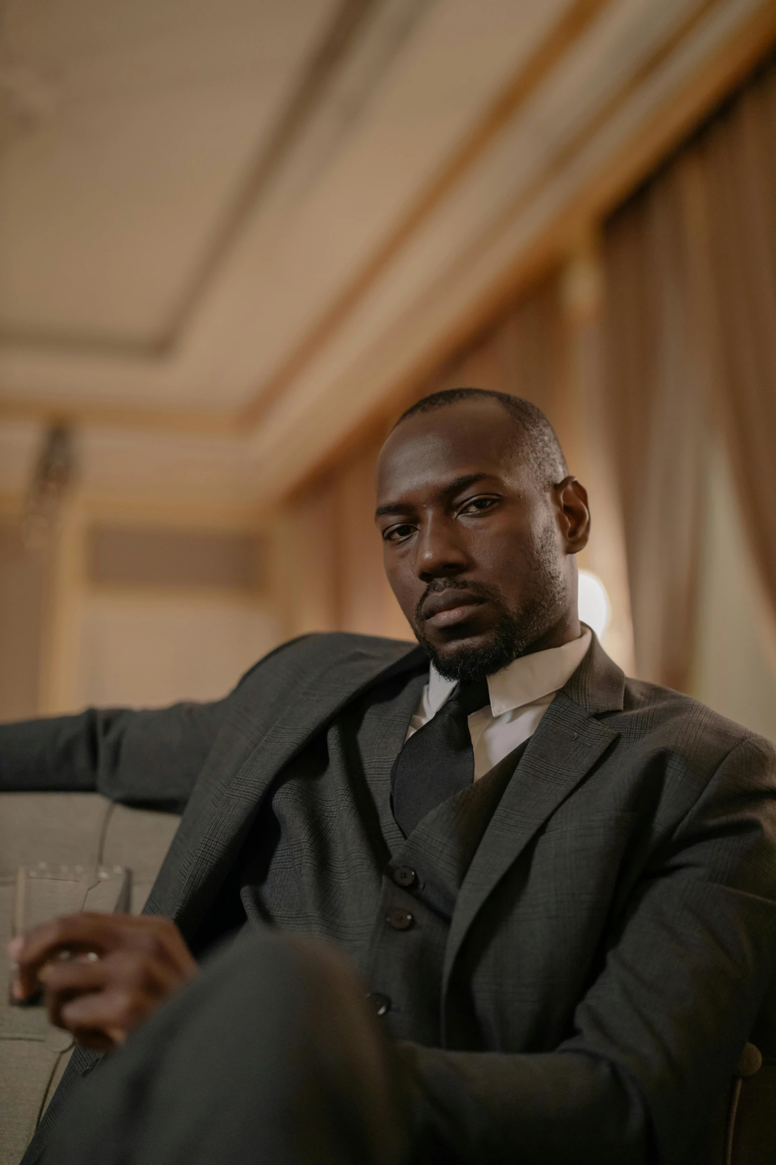 black man in suite and tie seated