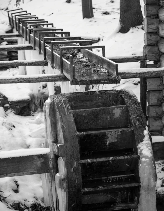 a wooden machine next to a pile of tires