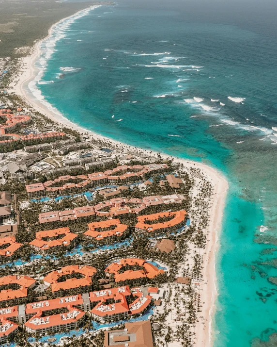 an aerial view of a resort next to the ocean, a screenshot, by Robbie Trevino, pexels contest winner, orange and turquoise, despacito, thumbnail, hyperdetailed photo