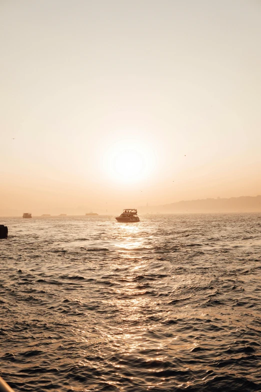 a couple of boats that are in the water, a picture, by Daniel Seghers, happening, in a sunset haze, istanbul, full sun, hazy