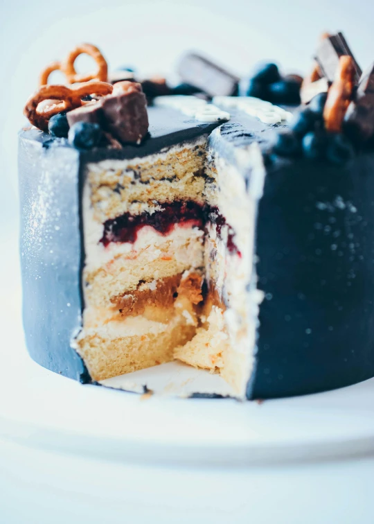 a close up of a piece of cake on a plate, navy, black, multiple layers, opening shot