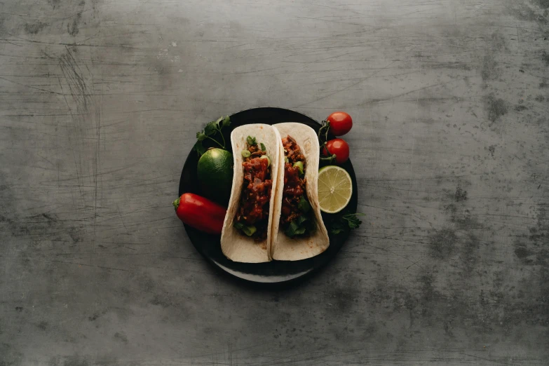 a couple of tacos sitting on top of a black plate, pexels contest winner, photorealism, background image, high resolution product photo, thumbnail, full body picture