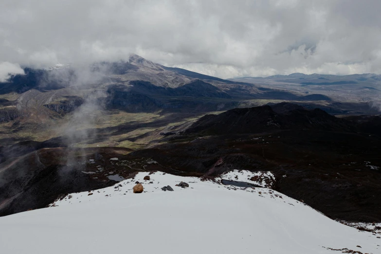 the snowy mountains are surrounded by fog