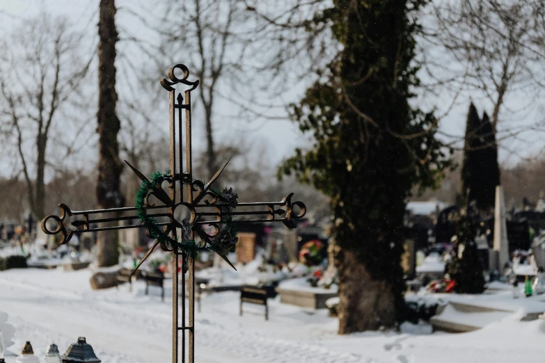 a cross that is standing in the snow