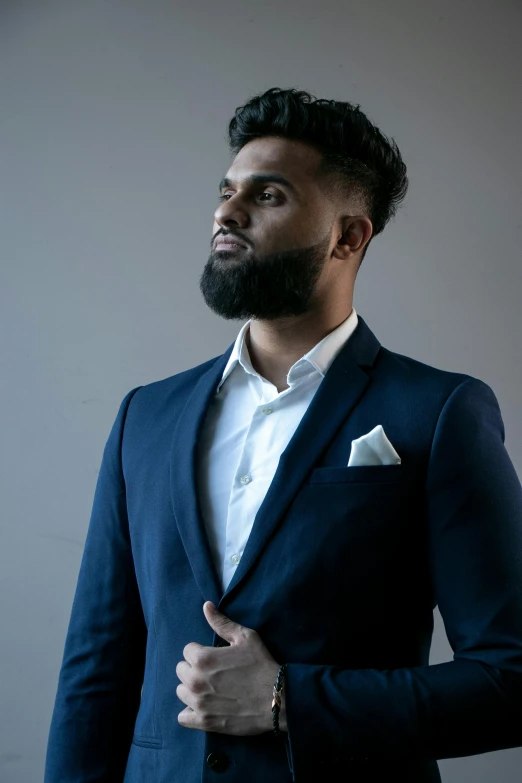 a man in a blue suit and white shirt, pexels contest winner, muslim, modeling shoot, rj palmer, thomas kinkad