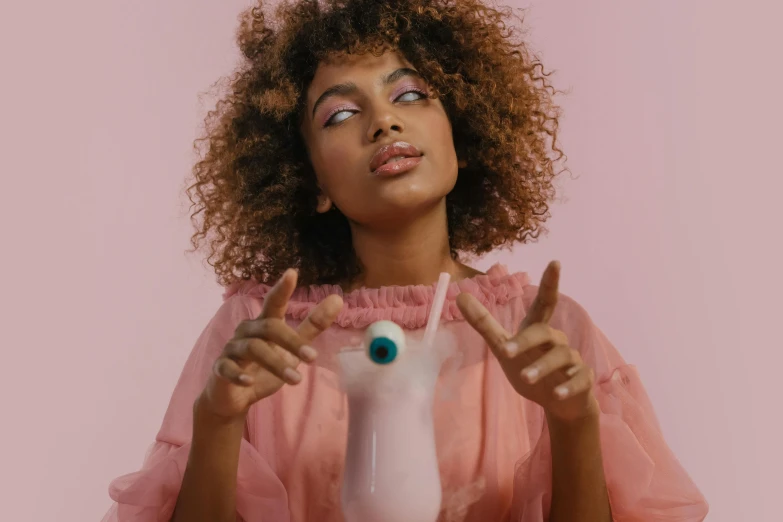 a beautiful woman holding up a fake cup