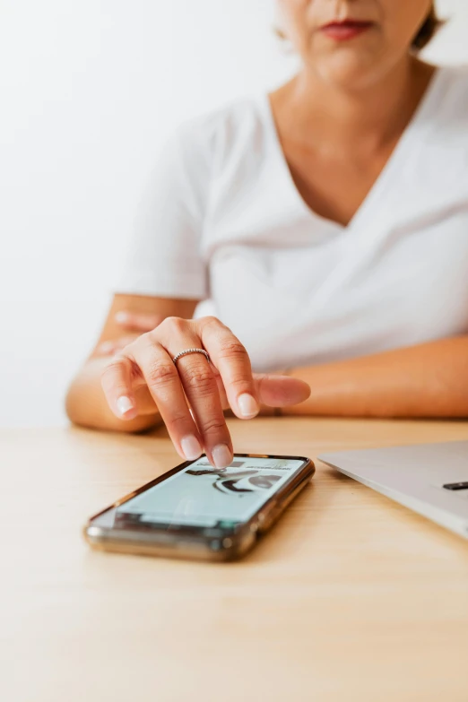 a woman sitting at a table with a laptop and a cell phone, trending on pexels, corporate phone app icon, worn, ilustration, carefully crafted