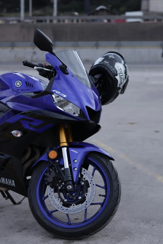 a blue motorcycle parked in a parking lot, ((purple)), r6, front light, profile image