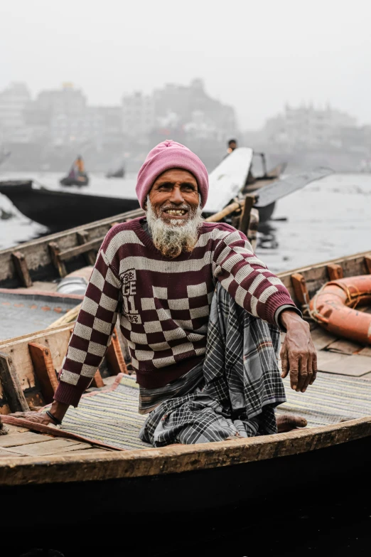 a man sitting in a boat on a body of water, inspired by Steve McCurry, pexels contest winner, renaissance, wearing festive clothing, old dhaka, smiling man, old charismatic mechanic