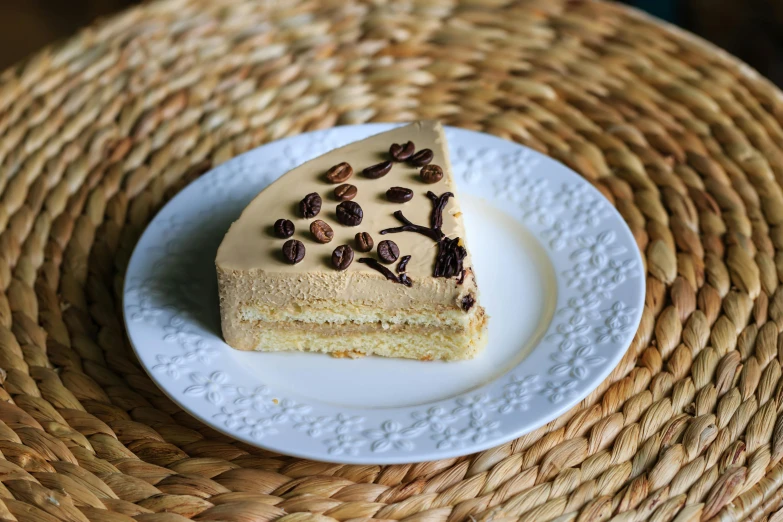 a piece of cake sitting on top of a white plate, inspired by François Louis Thomas Francia, unsplash, arabica style, beige, decorated, high quality product image”