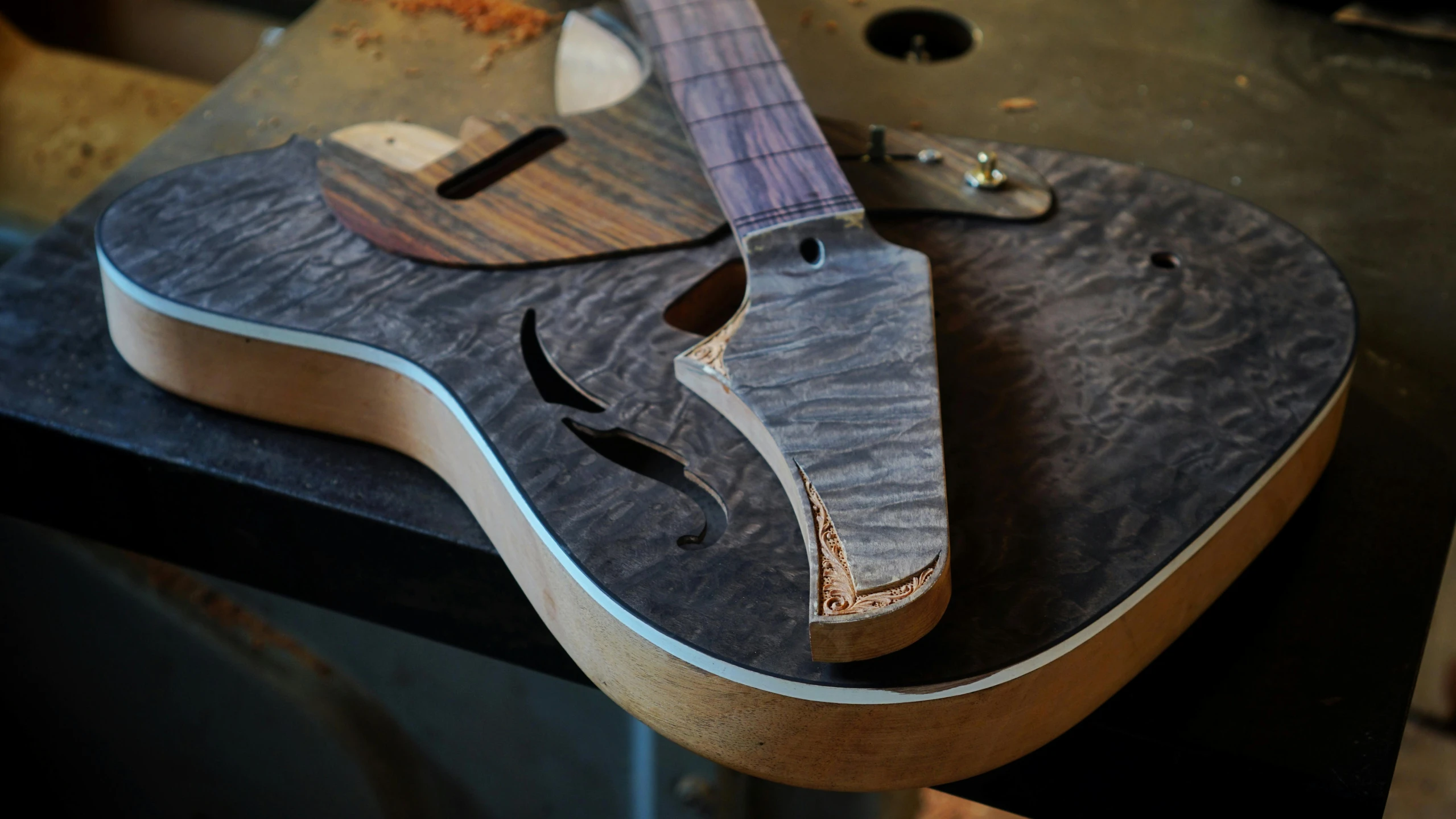 a close up of a guitar on a table, process art, restomod, dividing it into nine quarters, smoky, looking towards camera