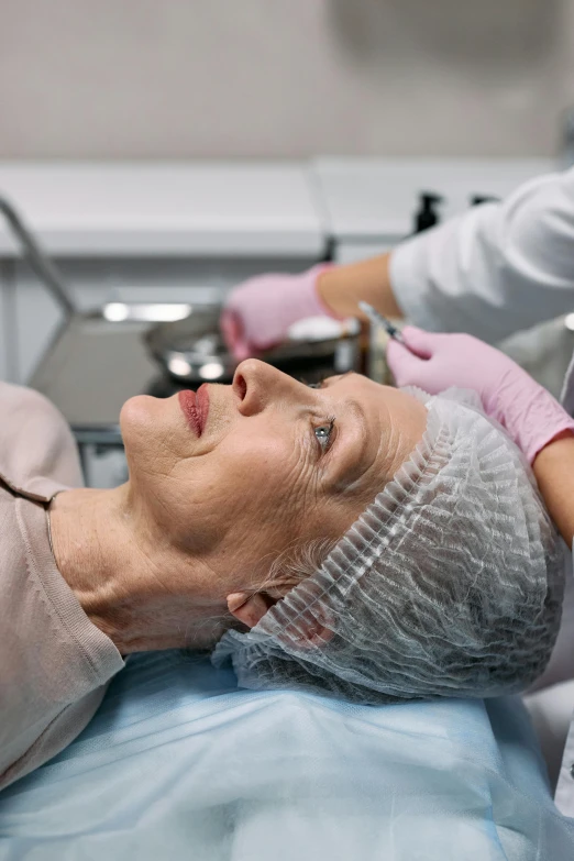 a close up of a person laying in a hospital bed, a photo, square facial structure, woman holding another woman, surgical supplies, synthetic skin