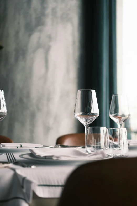 a table that has a bunch of wine glasses on it, by Jesper Knudsen, unsplash, renaissance, michelin starred restaurant, but minimalist, linen, victoria siemer
