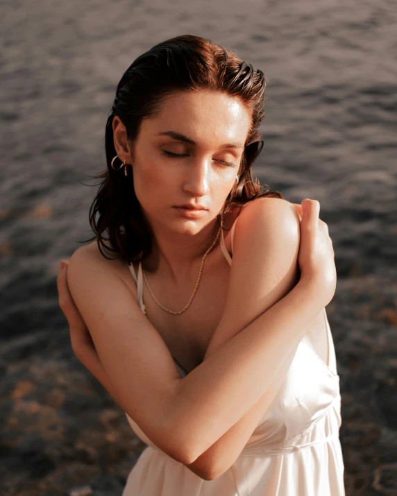 a woman standing in front of a body of water, pale beautiful skin, portrait sophie mudd, arm around her neck, non binary model