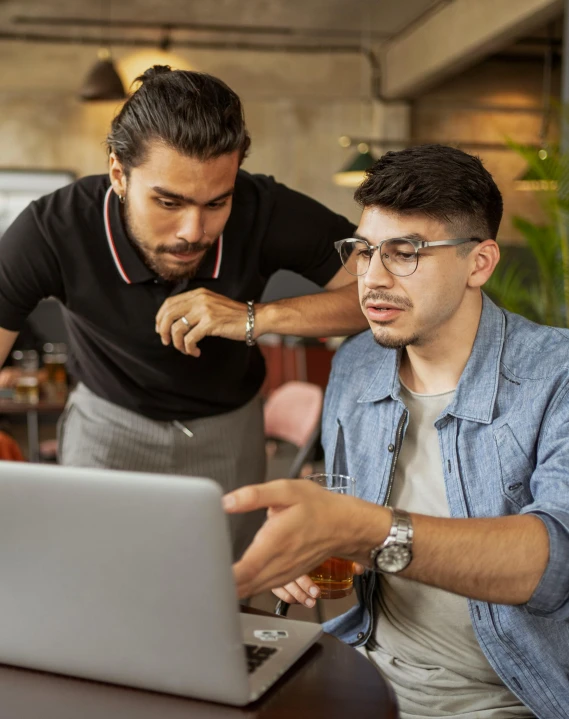 two men sitting at a table looking at a laptop, trending on pexels, renaissance, standing up, lgbt, aussie baristas, in a classroom