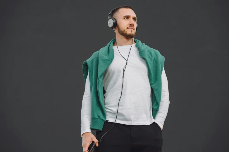 a man holding a headphone wearing headphones