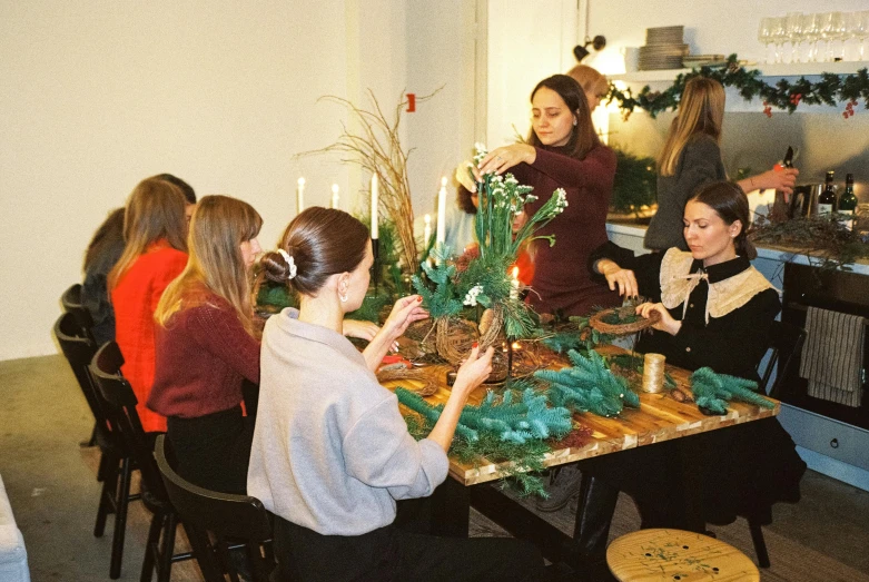 a group of women preparing and decorating a table