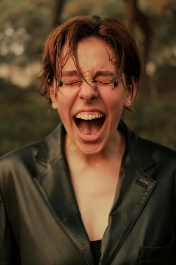 a woman in a leather jacket with her mouth open, an album cover, inspired by Jean Malouel, trending on pexels, screaming in pain, androgynous face, ecstatic expression, sweaty wet skin