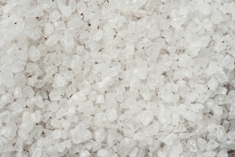 a pile of white salt sitting on top of a table, inspired by Howardena Pindell, trending on pexels, crystal cubism, candy treatments, high angle close up shot, heavy grain-s 150, detailed photo 8 k