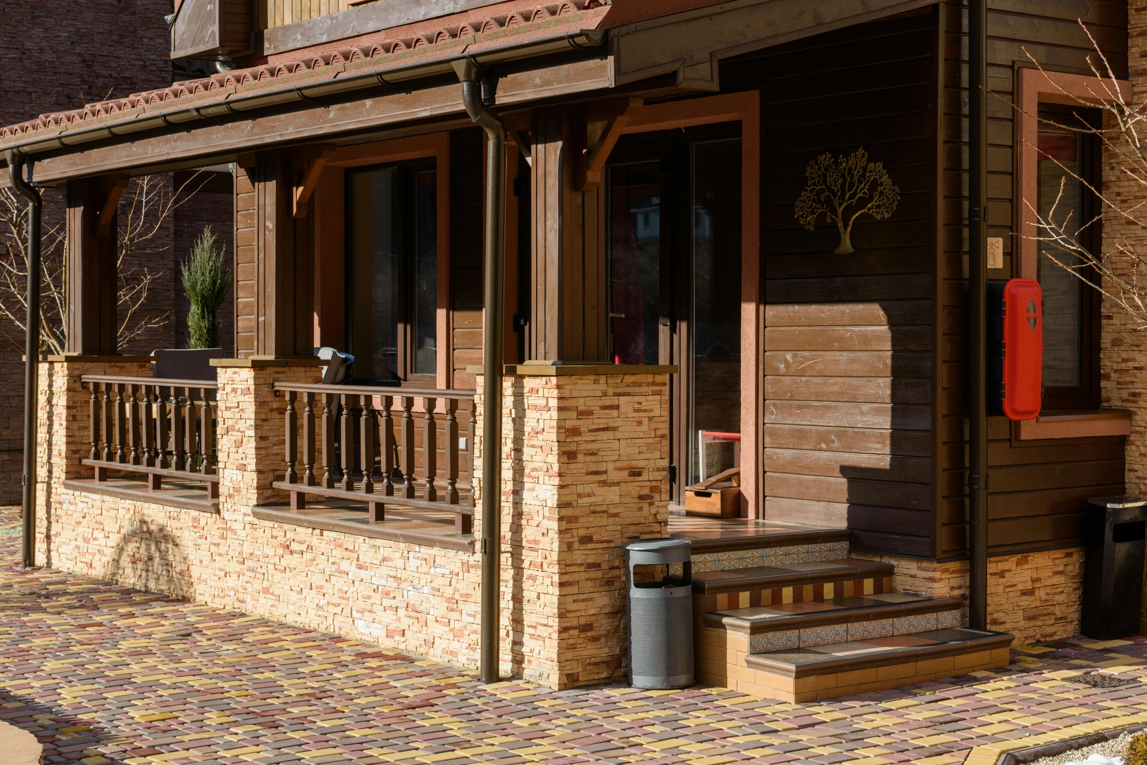 a wooden porch and a stairway leading up to an outside area