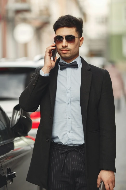 a man in a suit talks on his cell phone