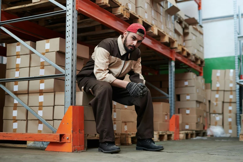 a man sitting on a pallet in a warehouse, techwear clothes, avatar image, brown, thumbnail