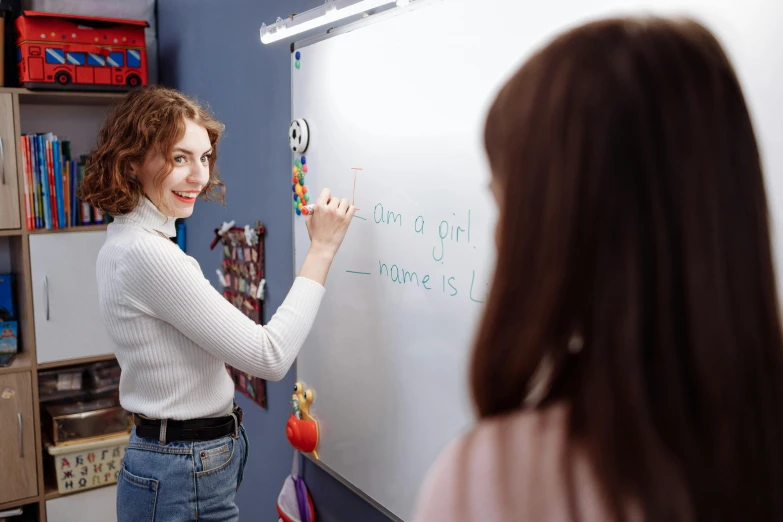 a woman writing on a white board in a classroom, trending on pexels, felicia day, dafne keen, lesbians, 15081959 21121991 01012000 4k