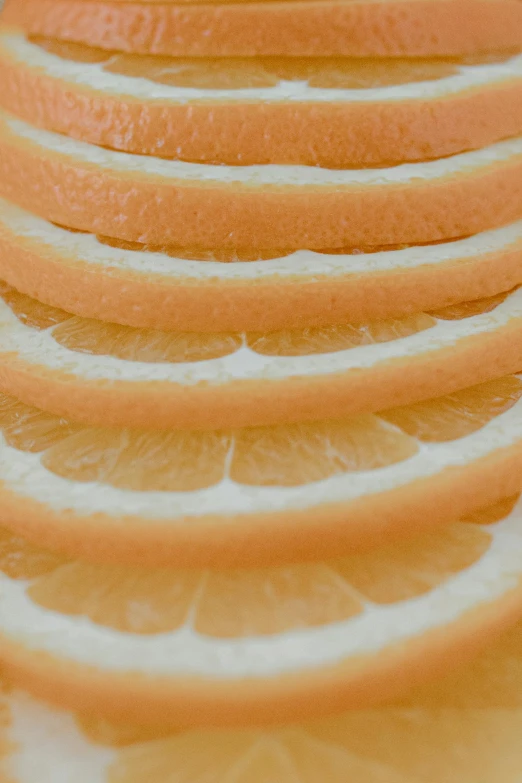 a close up of sliced oranges on a cutting board, a digital rendering, by David Simpson, pexels, op art, light orange mist, layers of strata, lemonade, detail shots