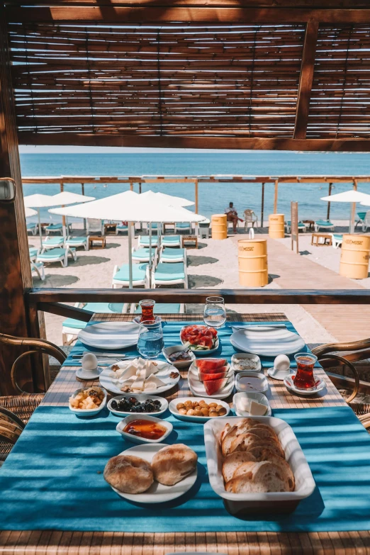 an outdoor table is set for two people with an outside view