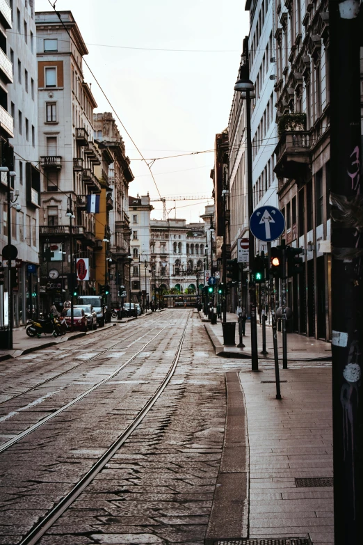 a street filled with lots of traffic next to tall buildings, a picture, pexels contest winner, renaissance, empty streetscapes, trams, milan jozing, late afternoon lighting