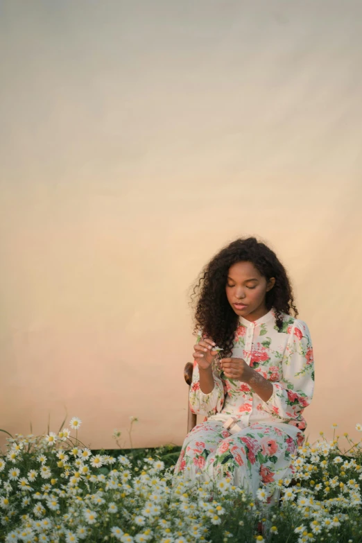 a woman sitting in a field of flowers looking at her phone, an album cover, trending on pexels, magic realism, tessa thompson inspired, soft sunset lighting, sza, artists portrait