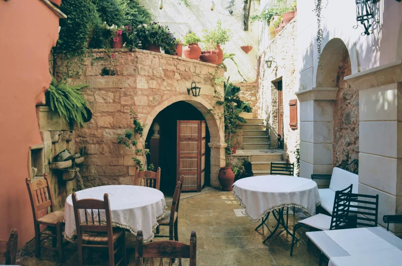 a very rustic courtyard with a staircase between two buildings