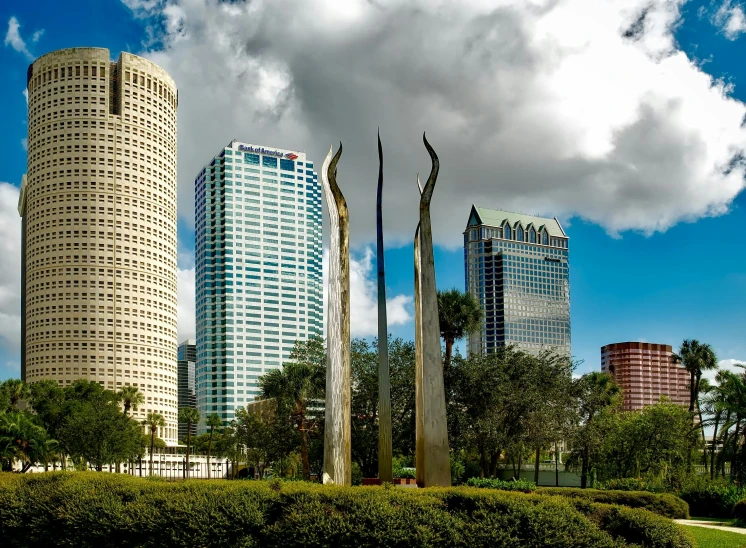 a blue building with sculptures in the foreground