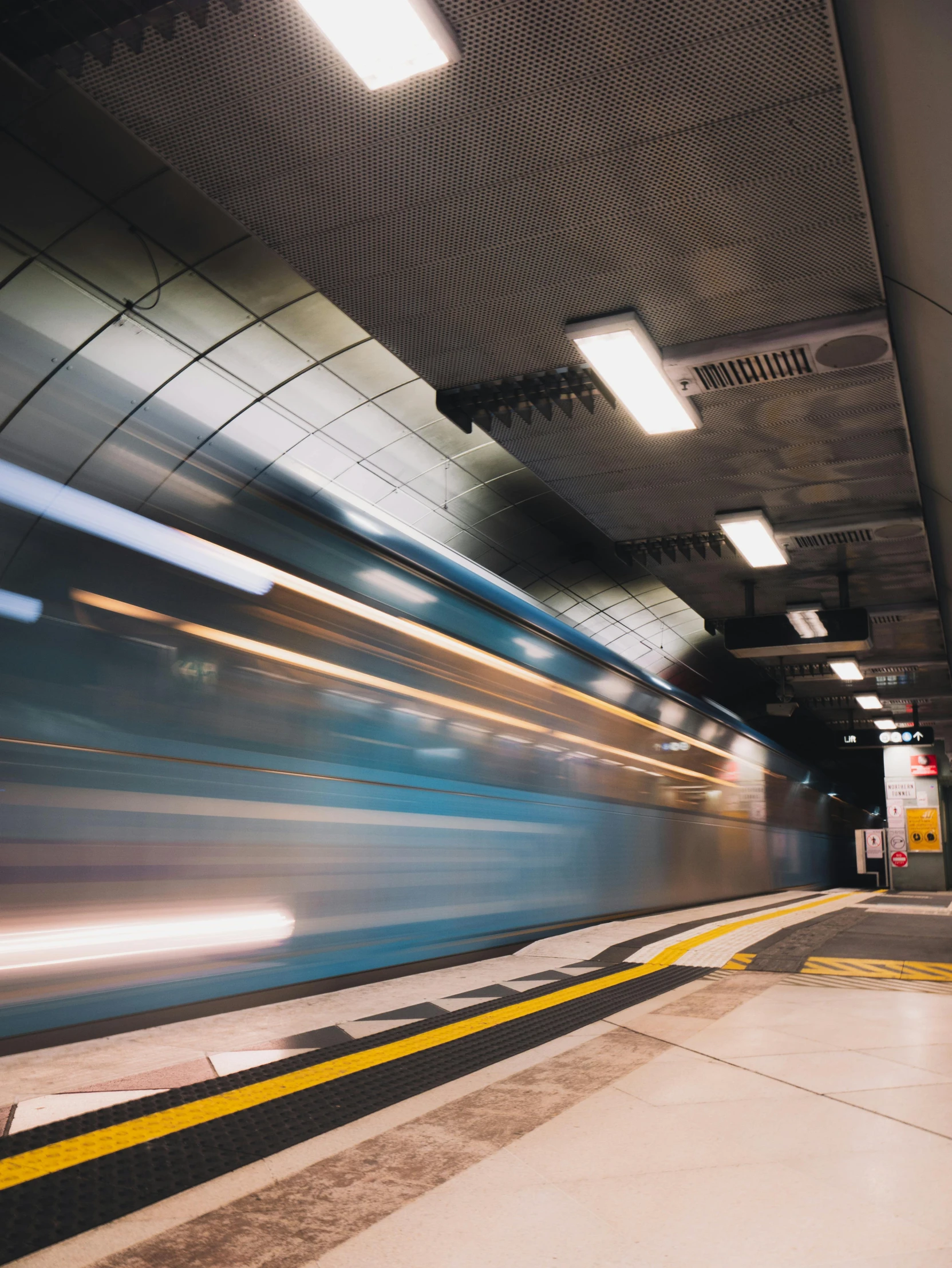 a train traveling through a train station next to a platform, by Carey Morris, unsplash contest winner, slow shutter speed, in an underground parking garage, jumping towards viewer, profile image