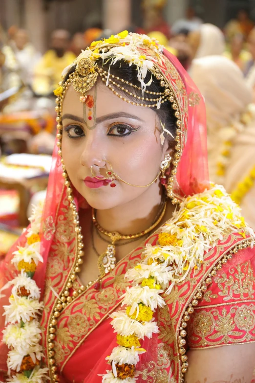 a woman dressed in a red and gold outfit, by Rajesh Soni, forehead jewelry, photo taken in 2018, square, wedding