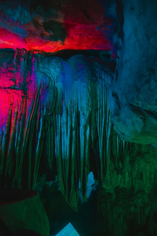 a group of people standing inside of a cave, unsplash contest winner, abstract expressionism, neon pillars, ice, beautiful deep colours, zhangjiajie