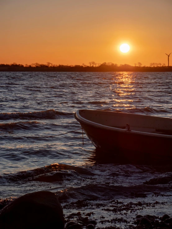 a boat sitting on top of a body of water, happening, at the golden hour, wind kissed pictures, slide show, sunset lighting 8k