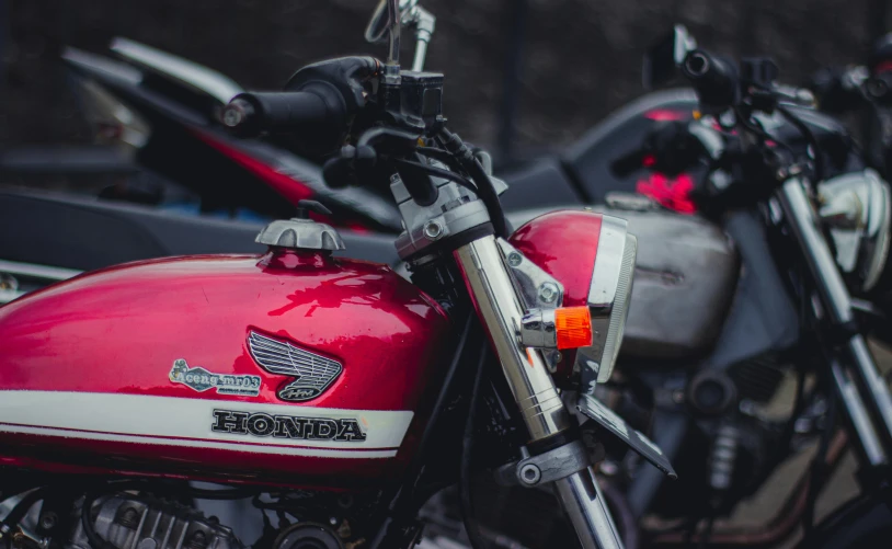 a couple of motorcycles parked next to each other, pexels contest winner, red mechanical body, close - up shot, hongbsws, profile image