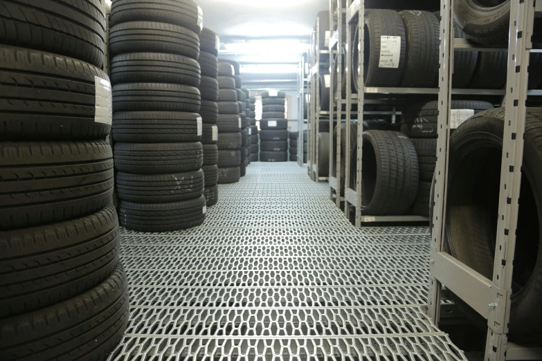 a room filled with lots of different types of tires, a portrait, shutterstock, bauhaus, high detail photo, metal floor, overview, medium height