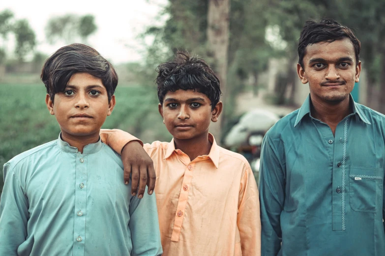 a group of young men standing next to each other, by Riza Abbasi, pexels contest winner, young boy, 256435456k film, full colored, innocent face