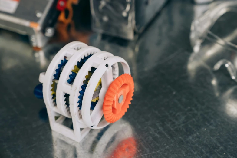 a close up of a device on a table, inspired by William Gear, 3d printed building, planetary gears, product introduction photo, robotics