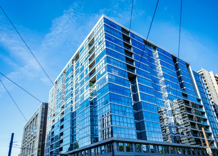 a very tall building with lots of windows, by Meredith Dillman, unsplash, seattle, blue and clear sky, square, 8k ”