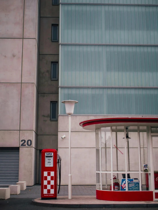 a red and white gas station next to a tall building, a photo, pexels contest winner, postminimalism, square, private academy entrance, phone photo, hyperdetailed!