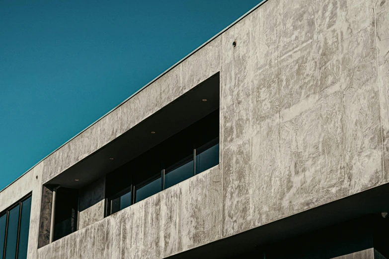 a concrete building with windows and a traffic sign