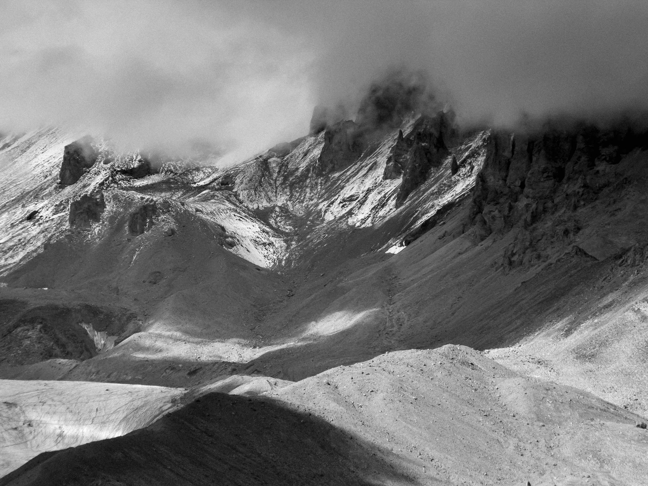 a snowy mountain landscape has white patches of snow on it