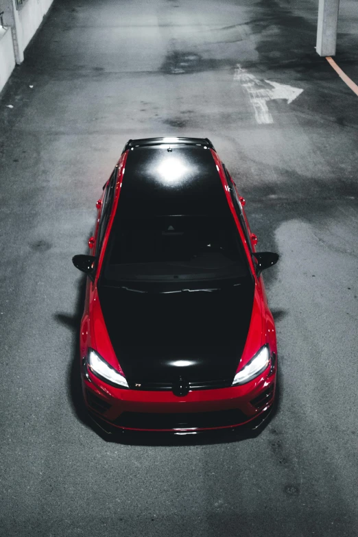 a red sports car parked in a parking space