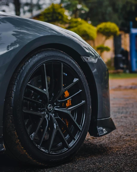 a black sports car parked on the side of the road, by Adam Marczyński, pexels contest winner, black wheel rims, extreme hyper detail, thumbnail, background image